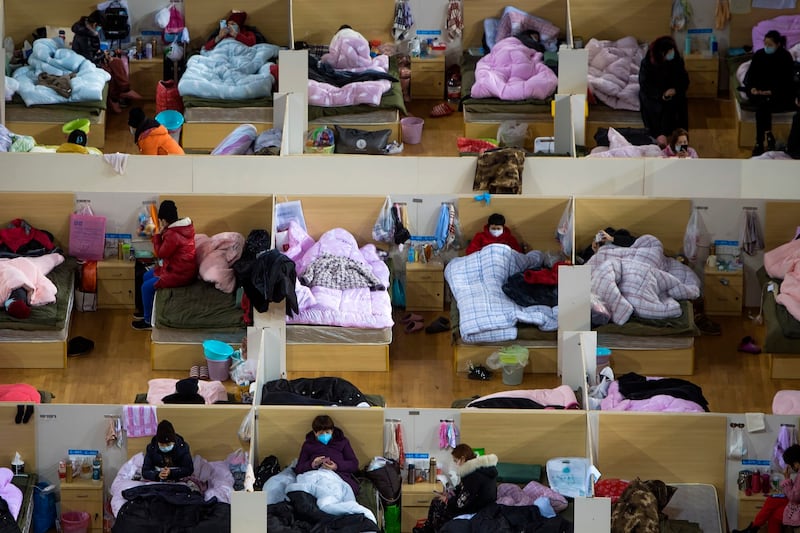 Patients infected with COVID-19 rest at a temporary hospital in the Wuhan Sports Center, Feb. 17, 2020. (Xiao Yijiu/Xinhua via AP)