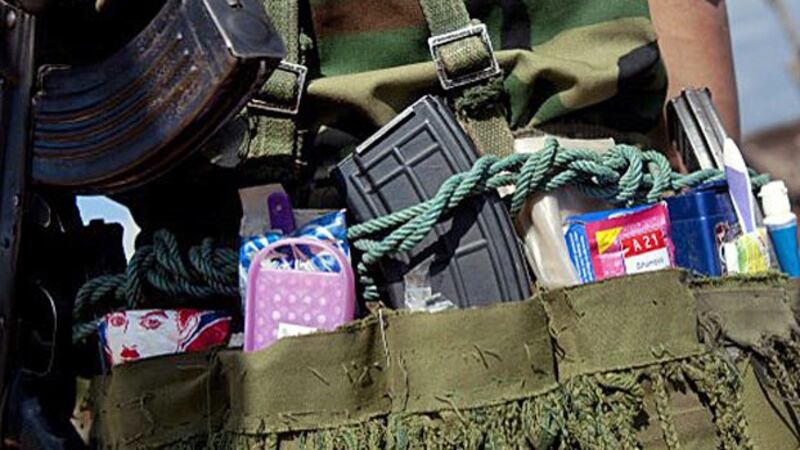 A soldier from the Ta'ang National Liberation Army carries a supply bag as he takes position in a village at Homain, Namhsan township, in Myanmar's northern Shan state in a file photo. 