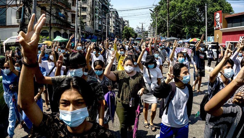 Protesters make the three-finger salute during a demonstration against the military coup in Yangon. (AFP)