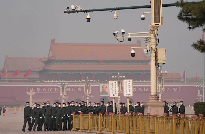 Security officers march in Tiananmen Square near the Great Hall of the People before a session of China's National People's Congress in Beijing, China, March 7, 2023.