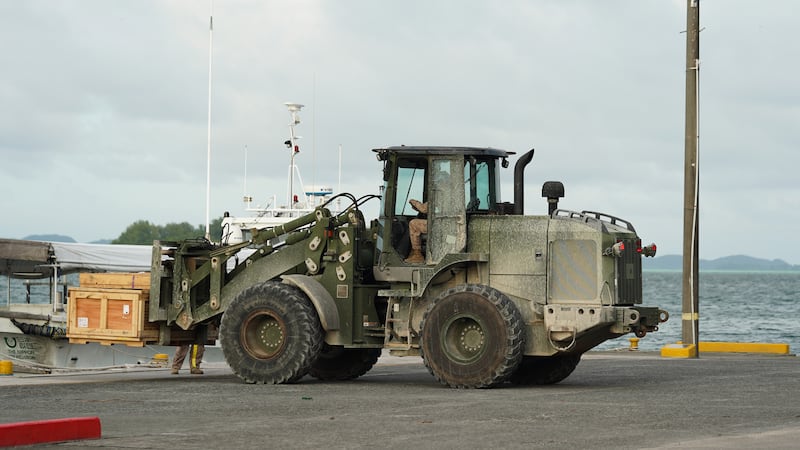 Heavy machinery operated by the U.S. Marines picks up supplies at the Peleliu wharf, Palau, Nov. 26.