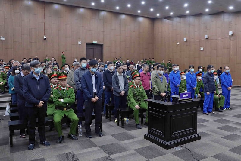 Thirty-eight defendants, including a former health minister stand in a courtroom during an anti-corruption trial in Hanoi, Jan. 3, 2024. (Vietnam News Agency via AFP)