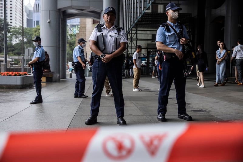 Police watch as the “League of Social Democrats” protests outside the headquarters of The Hong Kong and Shanghai Banking Corporation Limited (HSBC) in Hong Kong on Tuesday, June 6, 2023. Credit: AFP