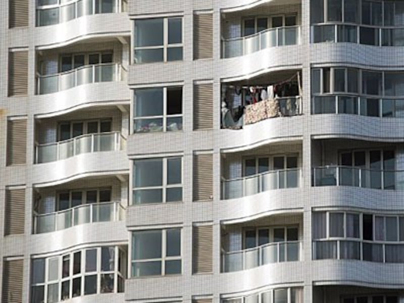 Clothes hang out to dry on a balcony of a residential building in the suburbs of Shanghai, Dec. 3, 2015.