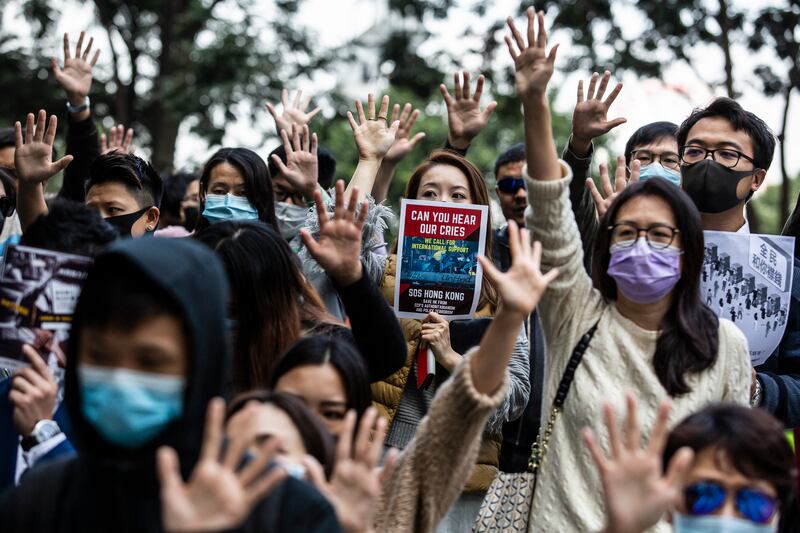 Office workers and protesters gather during a pro-democracy demonstration in the Central district in Hong Kong on Dec. 20, 2019.