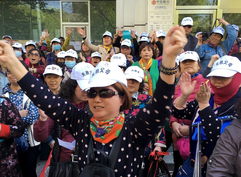 Petitioners are seen outside the National Health and Family Planning Commission of China in Beijing, in a file photo. Credit: Reuters