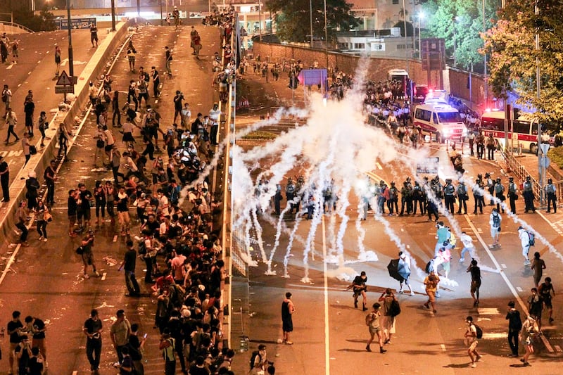 Riot police fire tear gas on student protesters occupying streets surrounding the government headquarters in Hong Kong, Sept. 29, 2014. (Wally Santana/AP)