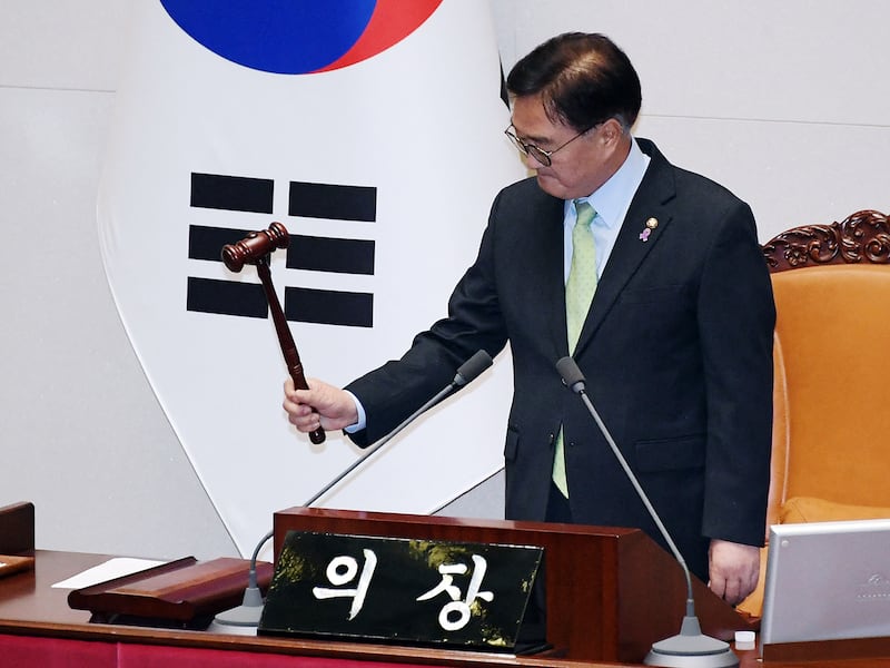 South Korea's National Assembly Speaker Woo Won-shik passes a resolution demanding the immediate lifting of martial law at the National Assembly in Seoul on Dec. 4, 2024.