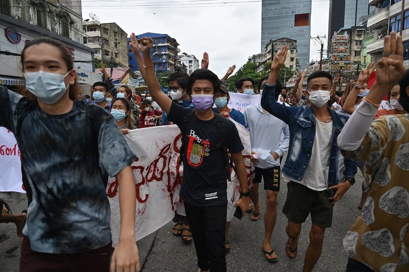 Protesters hold up a three-finger salute during a demonstration against the military coup in Yangon, July 11, 2021. AFP