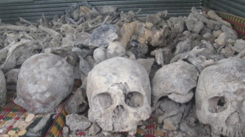 Human remains are gathered for a Buddhist ceremony at a mass grave site in Siem Reap province, Aug. 7, 2012. Credit: RFA