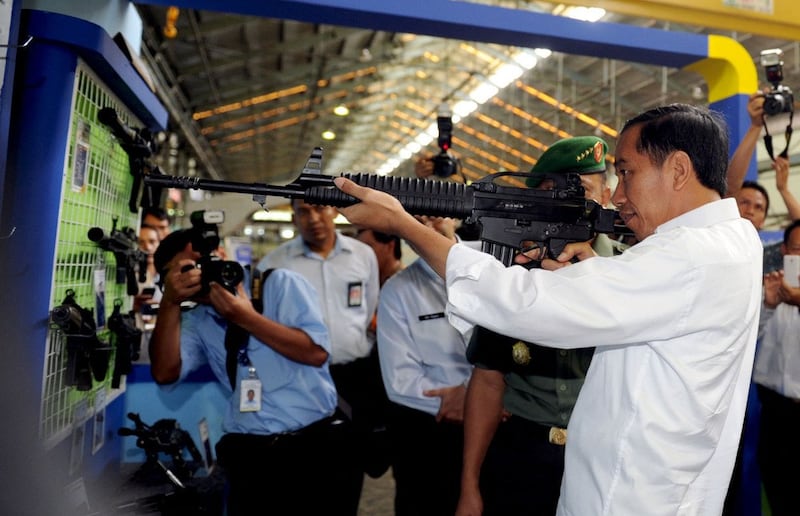 Indonesian President Joko “Jokowi” Widodo inspects a firearm during a visit to the state-owned PT Pindad plant in Bandung, Java, Jan. 12, 2015. Credit: Rusman/Presidential Palace via AFP