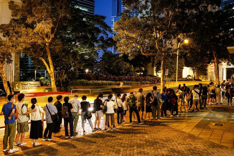 People queue up to pay tribute to Britain's Queen Elizabeth II outside the British Consulate-General in Hong Kong, Sept. 12, 2022. Credit: Reuters