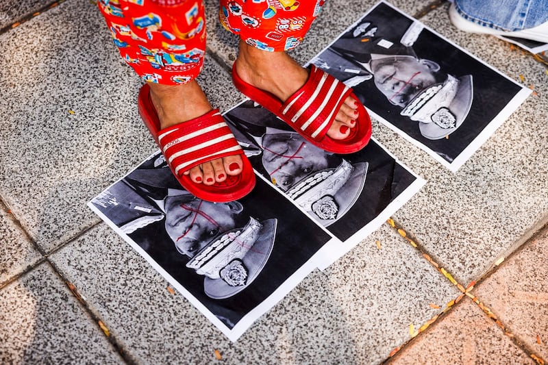 Myanmar citizens step on photos of military junta leader General Min Aung Hlaing, during a gathering at the United Nations, Feb. 01, 2024 in Bangkok, Thailand. (Lauren DeCicca/Getty Images)