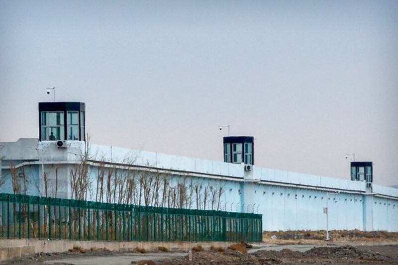 A person stands in a tower on the perimeter of the Number 3 Detention Center in Dabancheng in northwestern China's Xinjiang Uyghur Autonomous Region, April 23, 2021. (Mark Schiefelbein/AP)