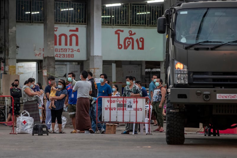 Migrant workers and their families are prepared to be taken to a field hospital for COVID-19 patients in Samut Sakhon, South of Bangkok, Thailand, Monday, Jan. 4, 2021.