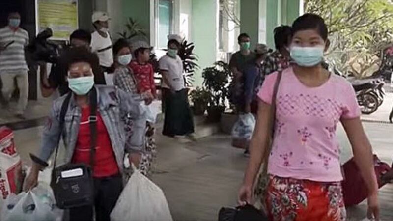 People leave a medical facility in Myanmar's capital Naypyidaw following a 14-day quarantine to ensure they had not contracted the coronavirus while abroad, April 8, 2020.