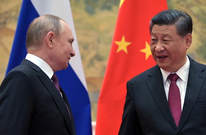 Russian President Vladimir Putin (L) and Chinese President Xi Jinping arrive to pose for a photograph during their meeting in Beijing, Feb. 4, 2022. Credit: Sputnik via AFP