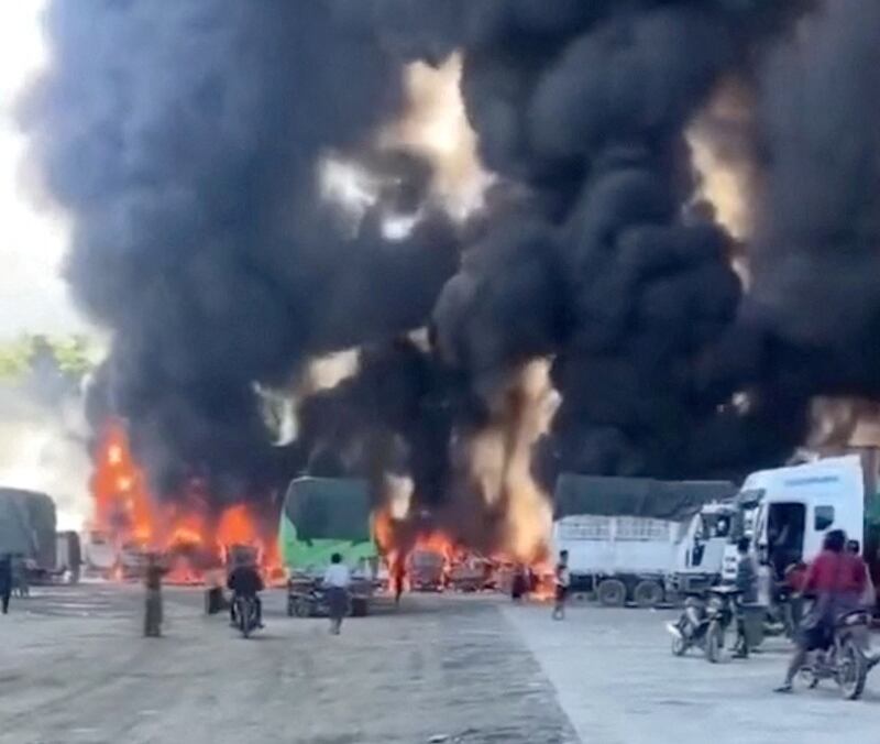 Smoke rises as a convoy of trucks burns near Muse on the Myanmar-China border in this screen grab obtained from a social media video released Nov. 23, 2023. (Screenshot from video obtained by Reuters)