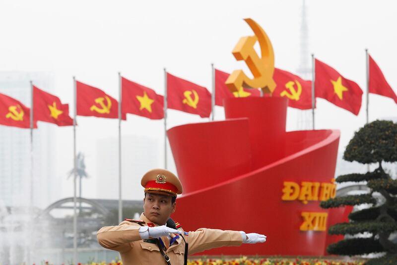 A police officer directs traffic outside the 13th National Congress of the ruling communist party of Vietnam in Hanoi, Jan. 26, 2021. (Kham/Reuters)