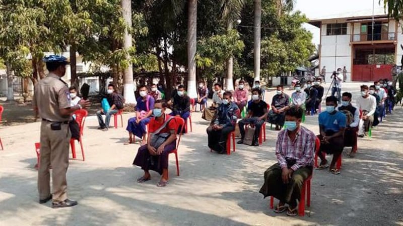 A prison official informs Myanmar inmates about coronavirus protection measures before they are released under a presidential amnesty marking the Buddhist New Year in Myanmar's capital Naypyidaw, April 17, 2020.