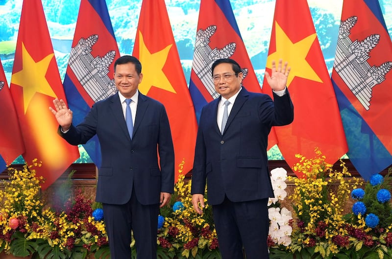 Vietnamese Prime Minister Pham Minh Chinh and Cambodian Prime Minister Hun Manet wave in Hanoi, Dec.11, 2023 during Manet's visit to boost bilateral relations between the two Southeast Asian nations. (Hau Dinh/AP)