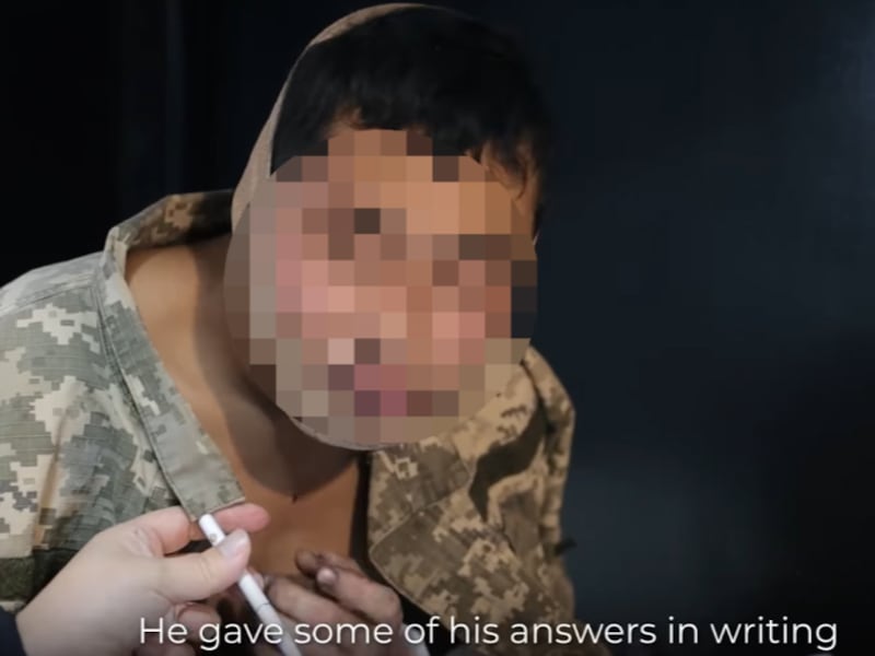 At the video’s two-minute and 36-second mark, someone can be seen handing over a pen to the man. Part of the image has been blurred by RFA.