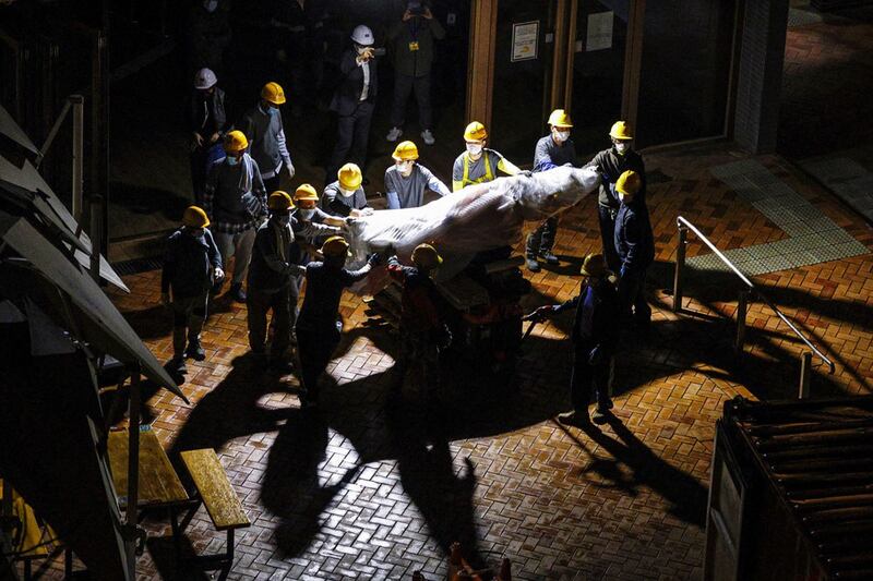 Workers remove a part of the "Pillar of Shame" at the University of Hong Kong. (Reuters)