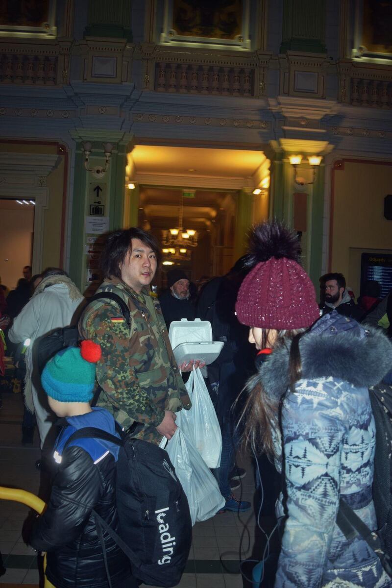 Yi Qiwei (C) stands in the Polish border city of Medyka in an undated photo, before crossing into Ukraine. Credit: Yi Qiwei