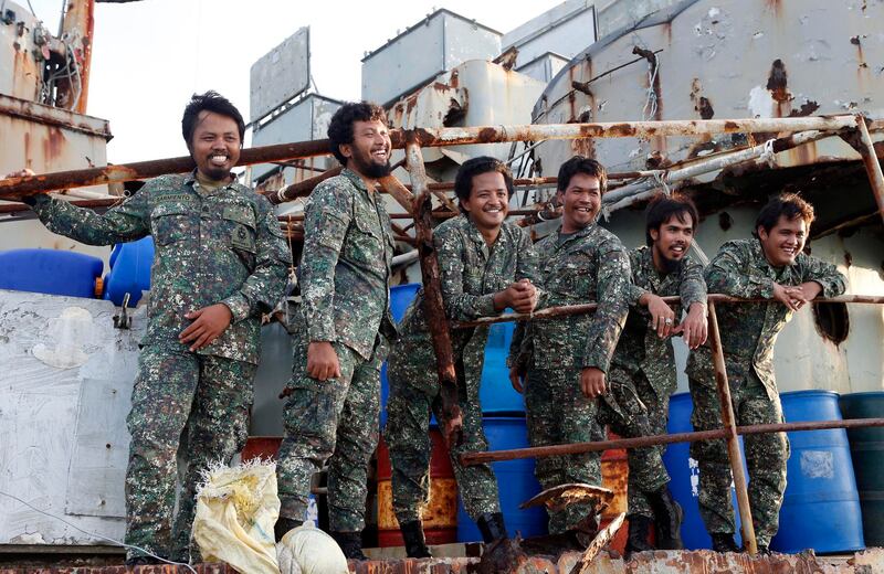 File photo showing Philippine marines aboard the BRP Sierra Madre and laughing at visiting local reporters in the South China Sea March 29, 2014, after Chinese Coast Guard vessels tried to block a resupply ship. Credit: Reuters