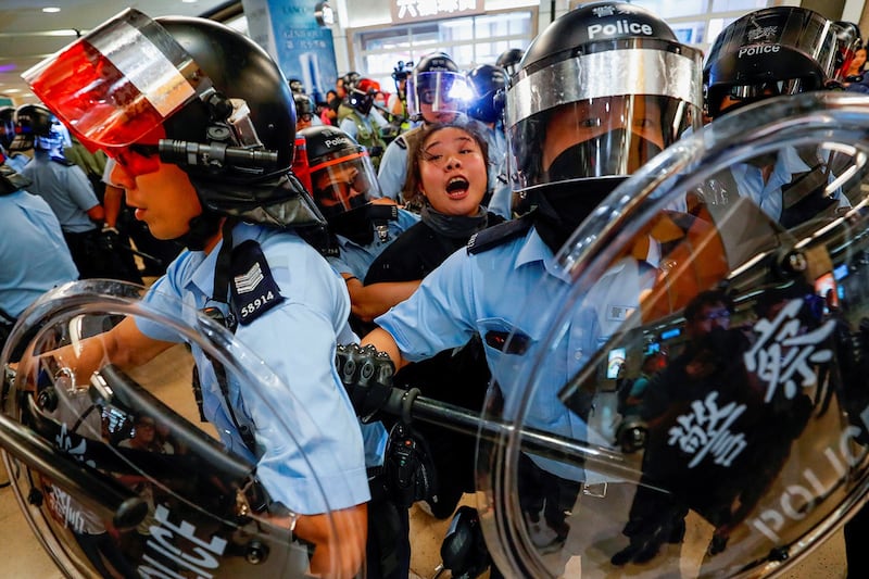 Riot police detain a woman as anti-government protesters gather at Sha Tin Mass Transit Railway station in Hong Kong, Sept. 25, 2019. (Tyrone Siu/Reuters)