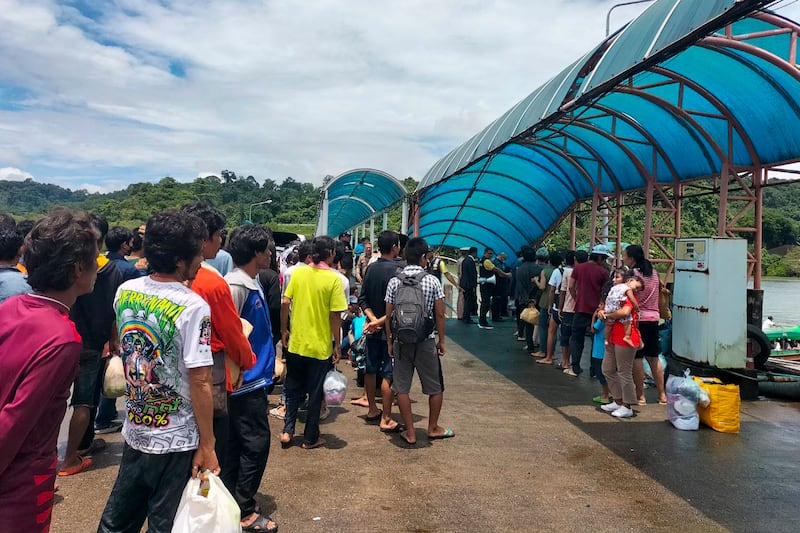 Myanmar citizens who will be repatriated to Kawthoung, Myanmar, are gathered at the port for deportation in Ranong, Thailand, Aug. 7, 2024. (Ranong Immigration Office via Facebook)