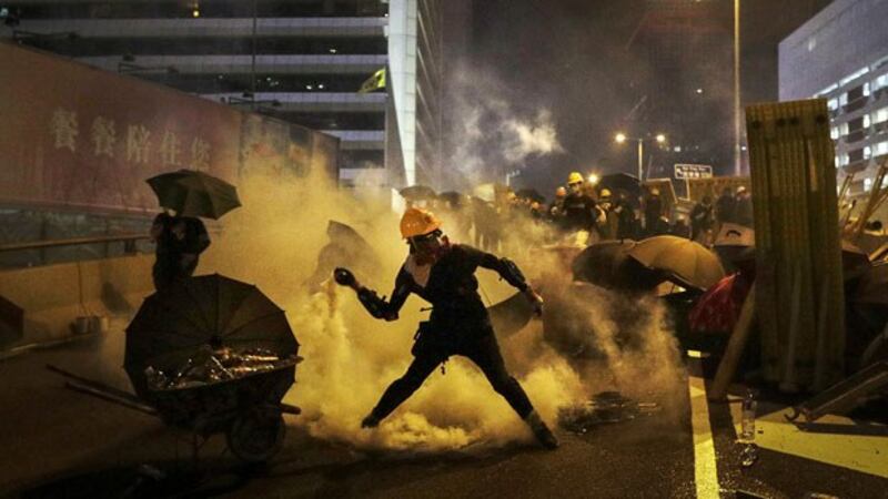 Protester throws tear gas canister back at police during a protest in Hong Kong, July 28, 2019.