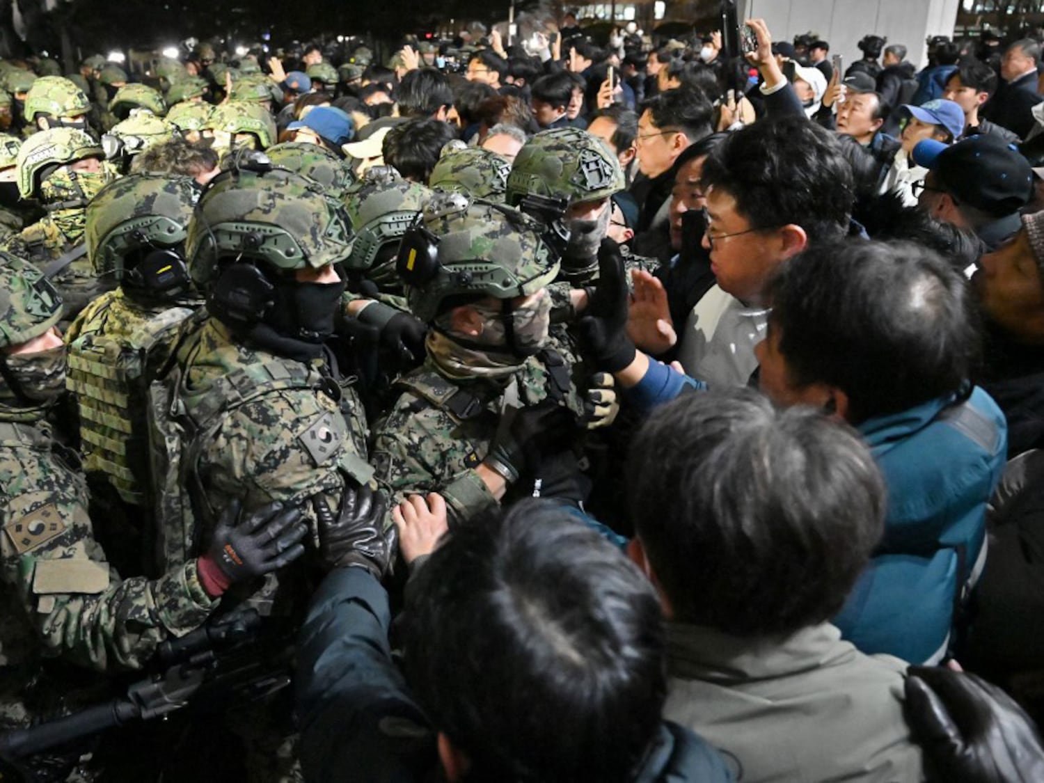 Soldiers try to enter the National Assembly building in Seoul on Dec. 4 2024, after South Korea President Yoon Suk Yeol declared martial law.