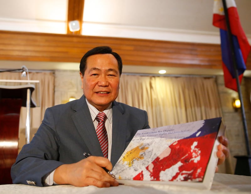 Philippine Supreme Court Senior Associate Justice Antonio Carpio holds a hard copy of his e-book "The South China Sea Dispute: Philippine Sovereign Rights and Jurisdiction in the West Philippine Sea" that questions China's historic claim to most of the South China Sea, May 4, 2017, Makati city, East of Manila, Philippines.