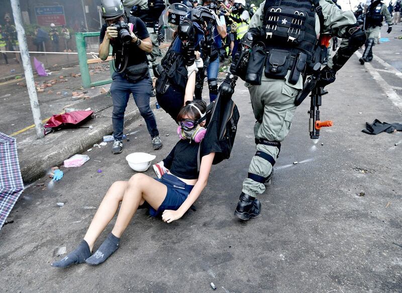 Protesters are detained by police near Hong Kong Polytechnic University. (AFP)