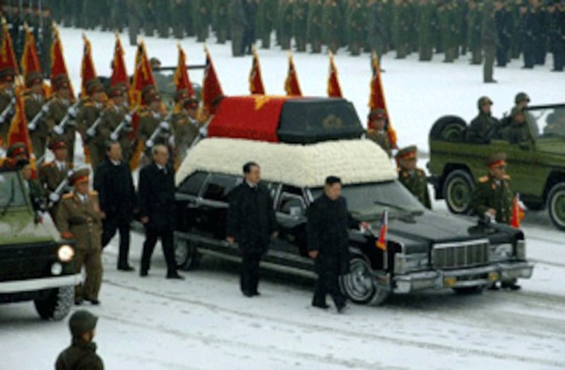 A photo by the official Korean Central News Agency shows Kim Jong Un (center R) and Jang Song-Thaek (C) besides the funeral convoy in Pyongyang, Dec. 28, 2011.