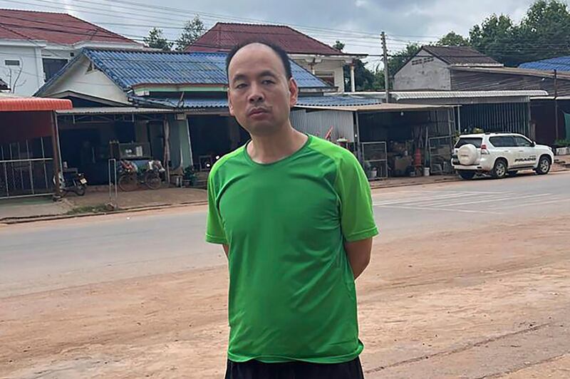 Chinese rights lawyer Lu Siwei stands along a road, at an undisclosed location, around 300 kilometers (186 miles) north of Vientiane, Laos, on July 27, 2023. He was heading south to the border with Thailand. Credit: Anonymous source via AP