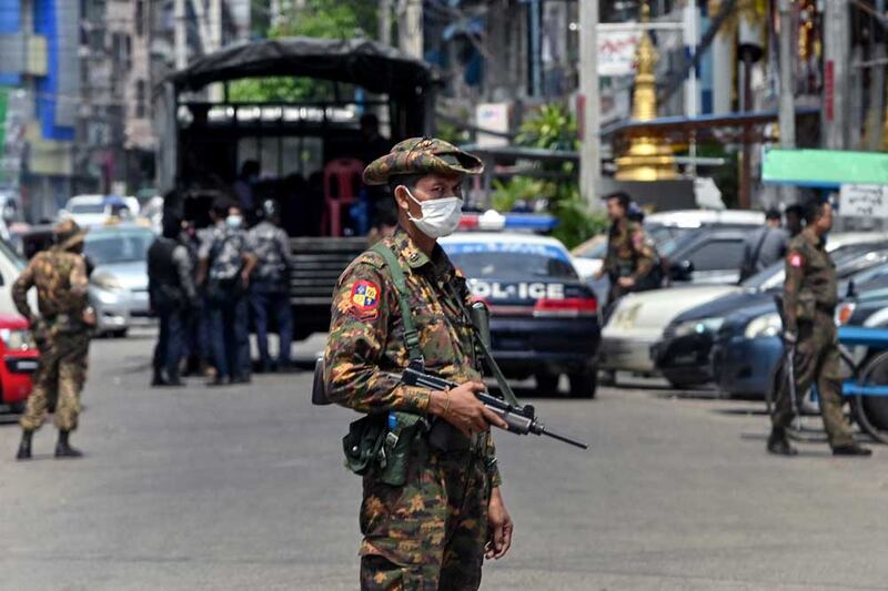 Junta soldiers search for protesters demonstrating against the coup in Yangon on May 7, 2021. (AFP)