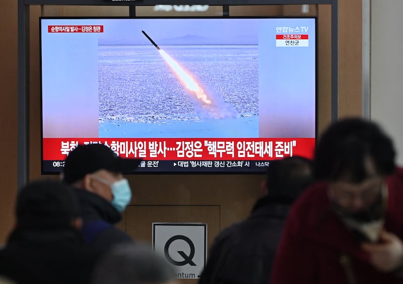 People watch a television screen showing news footage of North Korea's latest test-launch of strategic cruise missiles, at a train station in Seoul on February 28, 2025. North Korea conducted a "strategic cruise missile launching drill" in the Yellow Sea this week, Pyongyang's state media reported on February 28, saying the exercise sought to demonstrate the prowess of its "state nuclear deterrence". (Photo by Jung Yeon-je / AFP)