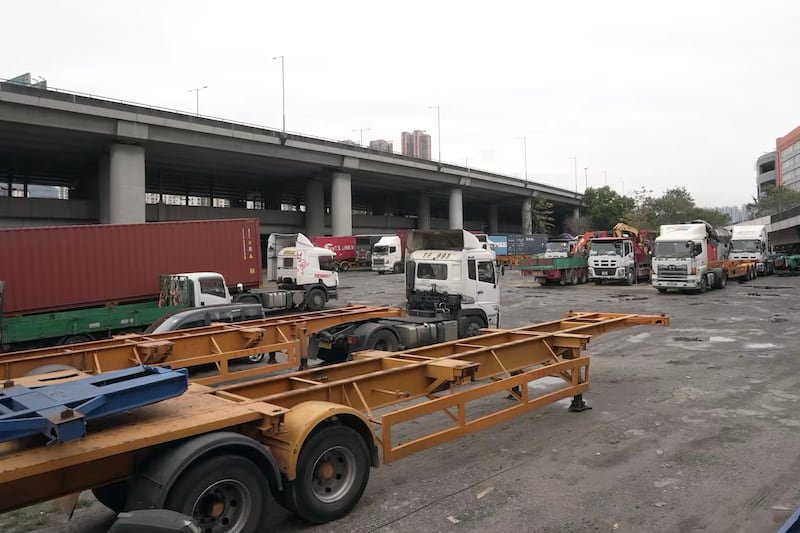 Container trucks wait in a temporary parking lot at Hong Kong's Kwai Chung Container Terminal, March 7, 2025.