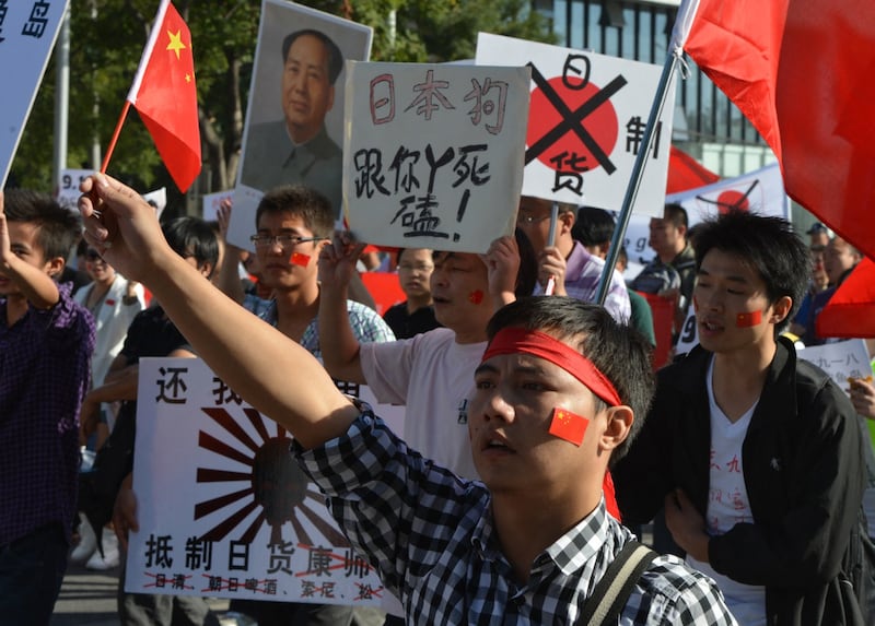 Anti-Japanese demonstrators march outside the Japanese embassy in Beijing, Sept. 18, 2012. (Mark Ralston/AFP)