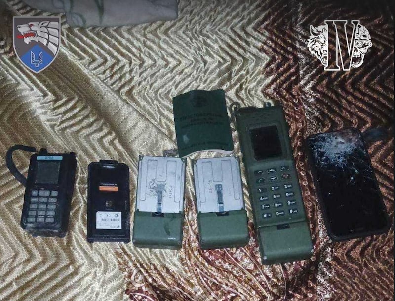 Ukraine’s 8th Special Operations Forces Regiment says this photo shows items of a fallen North Korean soldier in Kursk, including a drone detector (first from left).