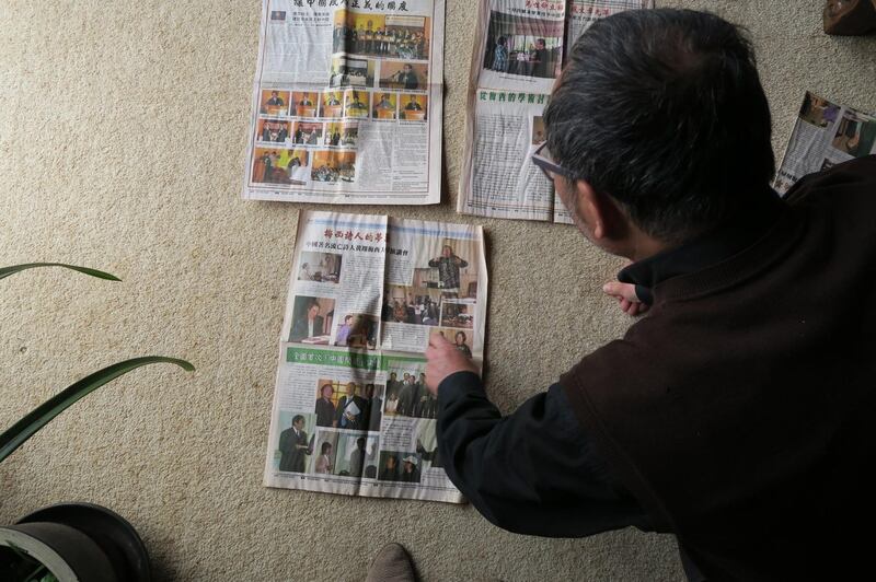 Chen Weijian looks at copies of his defunct New Times Weekly, which folded in 2011. Credit: Radio Free Asia