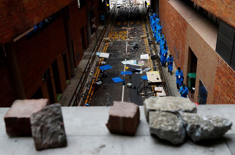 Protesters leave the Hong Kong Polytechnic University campus to surrender to police, in Hong Kong, Nov. 19, 2019.