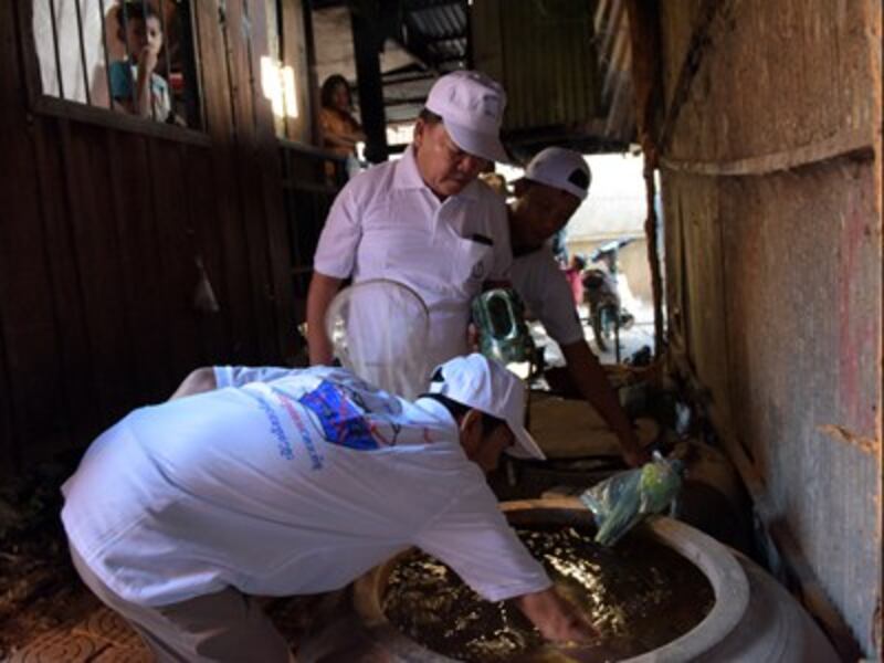 Cambodian health officials collect mosquito larvae from a container in an effort to stem an outbreak of the Zika virus in Phnom Penh, Feb. 4, 2016. 