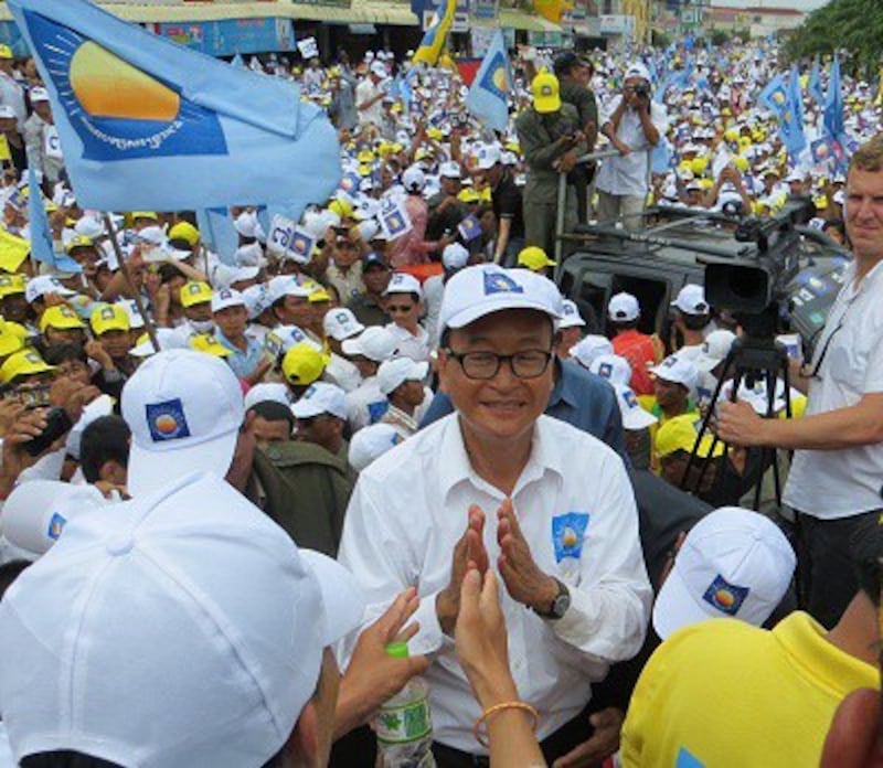 Sam Rainsy greets supporters at a Cambodia National Rescue Party rally in Kompong Cham, July 26, 2013. Photo credit: RFA.