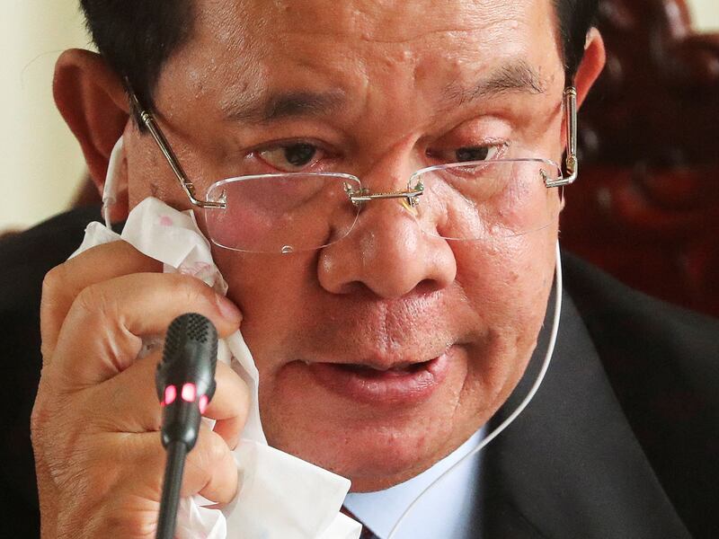 A teardrop rests on Hun Sen's glasses as he reacts at the National Assembly after a vote to confirm his son, Hun Manet, as Cambodia's prime minister in Phnom Penh, Aug. 22, 2023.