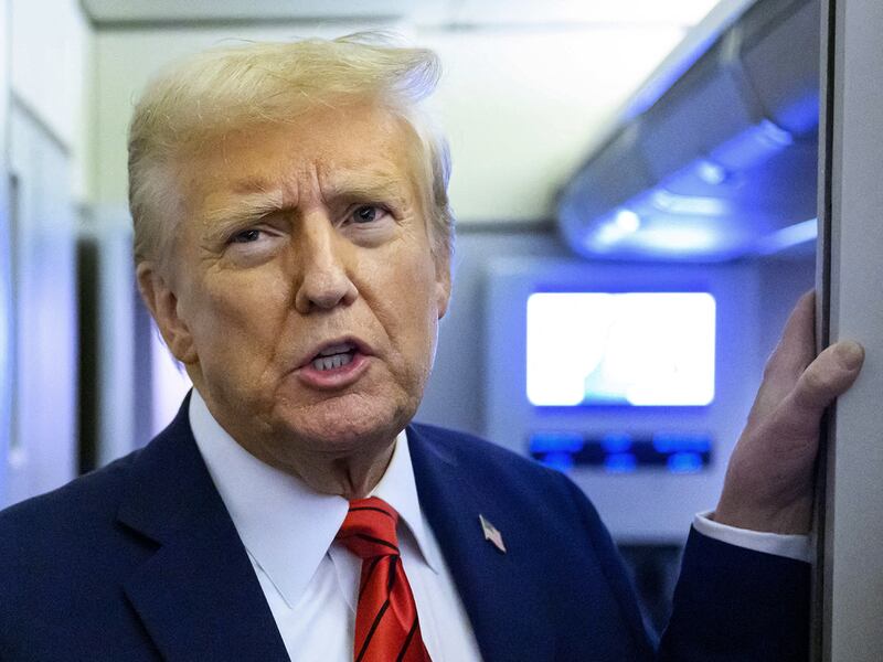 President Donald Trump speaks to reporters while in flight on Air Force One, Jan. 27, 2025.