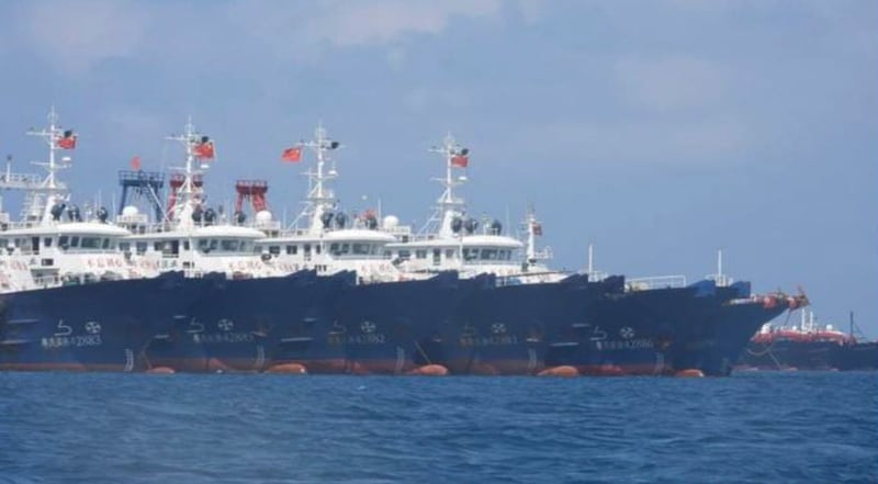 Chinese vessels moored at Whitsun Reef, South China Sea, in a March 7, 2021, photo provided by the Philippine Coast Guard. The Philippines believed the fishing vessels were believed were crewed by Chinese maritime militia. Credit: Philippine Coast Guard/National Task Force-West Philippine Sea via AP