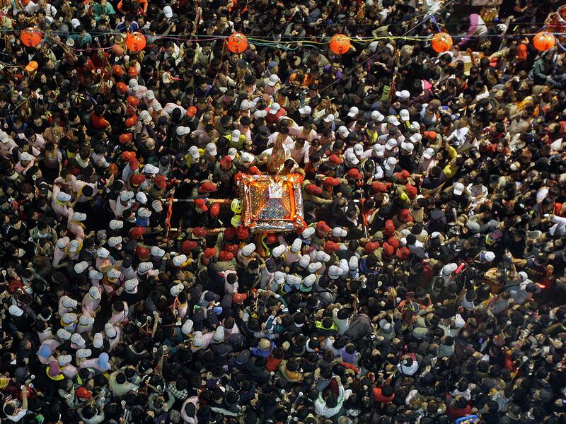 Worshippers carry the Matsu statue, center, during the annual pilgrimage in honor of sea goddess Matsu in Dajia, Taiwan, April 17, 2010.